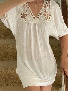 White tunic-style top.